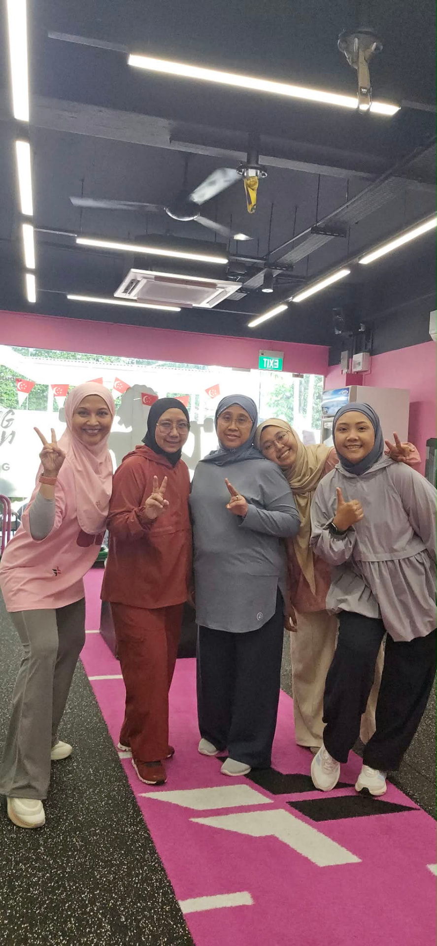 Five FitFab.sg members celebrating their workout together